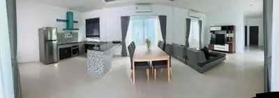 a living room with a table and a kitchen at Bests Villa - Rawai Beach Phuket in Rawai Beach