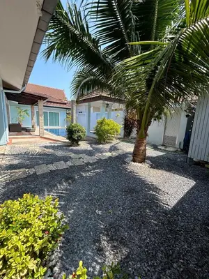 a palm tree in front of a house at Bests Villa - Rawai Beach Phuket in Rawai Beach
