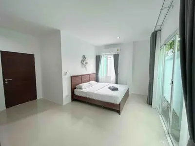 a white bedroom with a bed and a window at Bests Villa - Rawai Beach Phuket in Rawai Beach