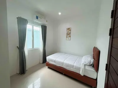 a small bedroom with a bed and a window at Bests Villa - Rawai Beach Phuket in Rawai Beach