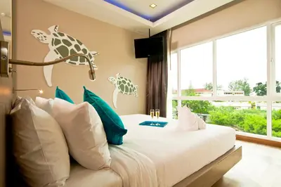 a bedroom with a bed with a giraffe mural on the wall at Ratana Platinum Resort Kamala in Kamala Beach