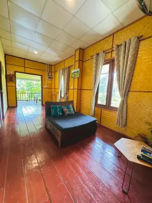 a living room with a couch and a table at Bang Mee Homestay Koh Yao Noi in Ko Yao Noi