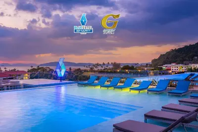 a large swimming pool with blue and yellow lounge chairs at BlueSotel SMART Krabi Aonang Beach - Adults only in Ao Nang Beach