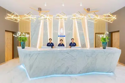 a group of people sitting at a reception desk at BlueSotel SMART Krabi Aonang Beach - Adults only in Ao Nang Beach