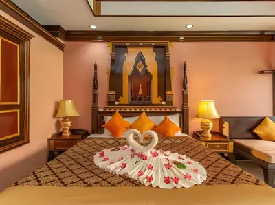 a hotel room with a bed with a heart decoration on it at Ayodhaya Palace Beach Resort - SHA Plus certified in Ao Nang Beach