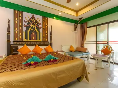 a bedroom with a king sized bed in a room at Ayodhaya Palace Beach Resort - SHA Plus certified in Ao Nang Beach