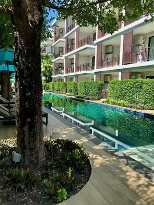 a swimming pool in front of a building at Title Rawai Phase III by Beringela in Rawai Beach