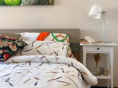 a bedroom with a bed and a table with a lamp at Title Rawai Phase III by Beringela in Rawai Beach