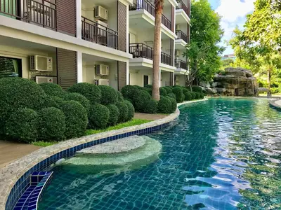 a swimming pool in front of a building at Title Rawai Phase III by Beringela in Rawai Beach