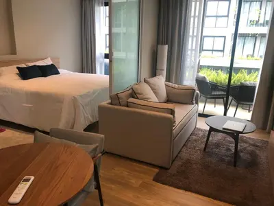 a bedroom with a bed and a couch and a table at Amazing Apartment in Diamond Condominium, Bang Tao Beach in Bang Tao Beach