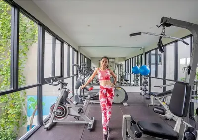 a woman walking in a gym at Amazing Apartment in Diamond Condominium, Bang Tao Beach in Bang Tao Beach
