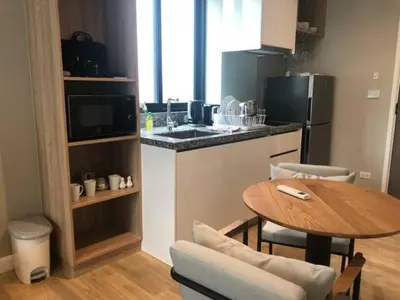 a small kitchen with a table and a counter top at Amazing Apartment in Diamond Condominium, Bang Tao Beach in Bang Tao Beach