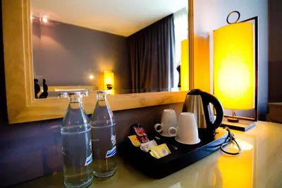 two bottles of water on a table in a hotel room at Ramaburin Resort Patong - SHA Extra Plus in Patong Beach