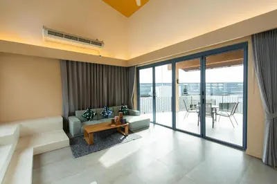 a living room with a couch and a table at Teetara Villa Patong in Patong Beach