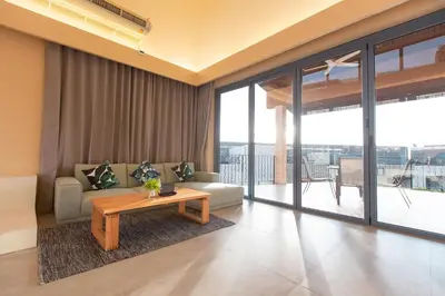 a living room with a couch and a table at Teetara Villa Patong in Patong Beach