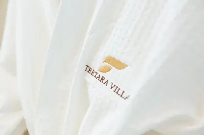 a white shirt with the word trending wind on it at Teetara Villa Patong in Patong Beach