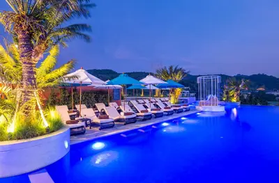 a pool with chairs and umbrellas at a resort at Anda Sea Tales Resort-SHA Plus in Ao Nang Beach