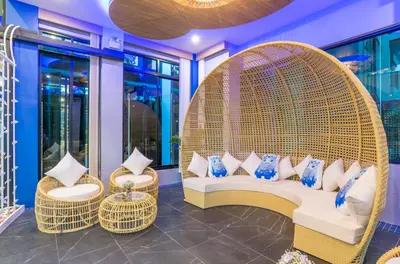 a room with a wicker bench and two chairs at Anda Sea Tales Resort-SHA Plus in Ao Nang Beach