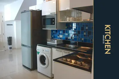 a kitchen with a refrigerator and a washing machine at 3 BR Amazing Condo with Private Rooftop Pool in Kamala Beach
