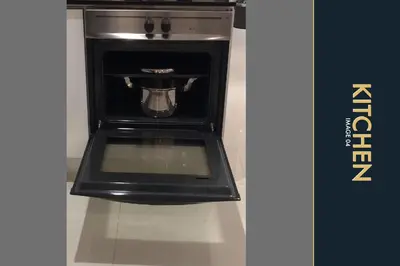 a black toaster oven with a pot in it at 3 BR Amazing Condo with Private Rooftop Pool in Kamala Beach