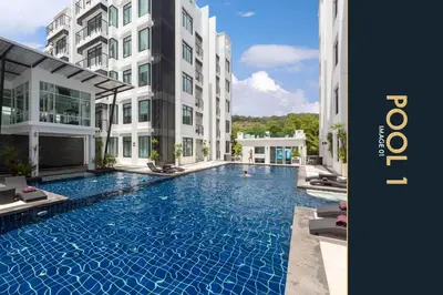 a swimming pool in the middle of a building at 3 BR Amazing Condo with Private Rooftop Pool in Kamala Beach