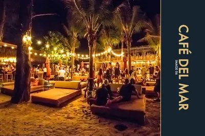 a group of people sitting on the beach at night at 3 BR Amazing Condo with Private Rooftop Pool in Kamala Beach