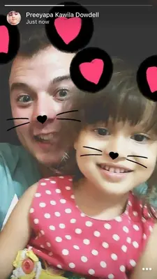 a man and a girl in a polka dot dress with a cat face at Connexion in Ko Yao Noi