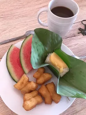 a plate of food with watermelon and a cup of coffee at Connexion in Ko Yao Noi