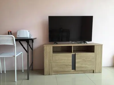 a wooden entertainment center with a television on top at Connexion in Ko Yao Noi
