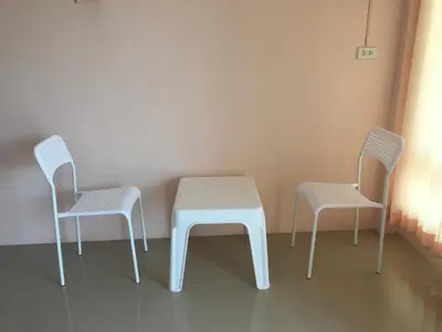 three chairs and a table in a room at Connexion in Ko Yao Noi
