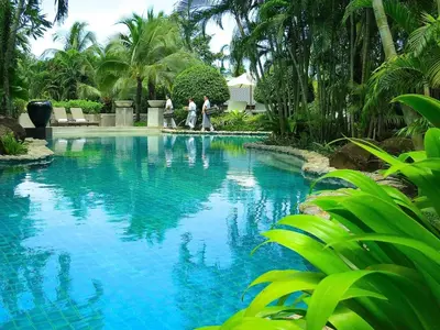 a group of people walking around a swimming pool at Villa on The Rocks, 4 bedrooms, Phuket in Surin Beach