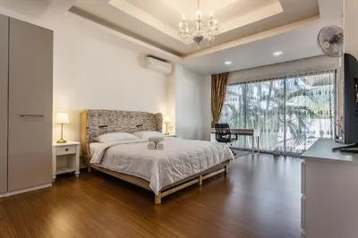 a bedroom with a bed and a large window at Villa Status in Nai Harn Beach