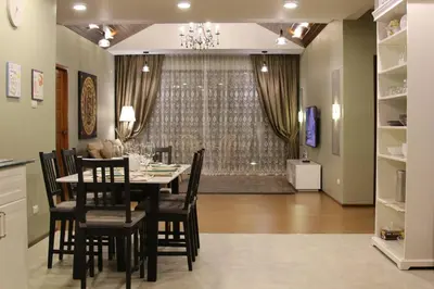 a dining room with a table and some chairs at Villa Status in Nai Harn Beach