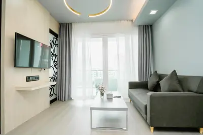 a living room with a couch and a tv at SLEEP WITH ME HOTEL design hotel @ patong (SHA Plus+) in Patong Beach