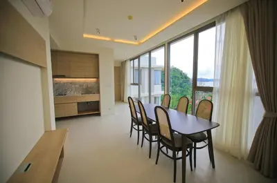 a dining room with a table and chairs and large windows at Rocco Aonang Krabi in Ao Nang Beach