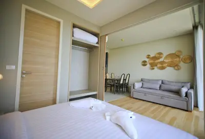 a bedroom with a bed and a couch and a table at Rocco Aonang Krabi in Ao Nang Beach