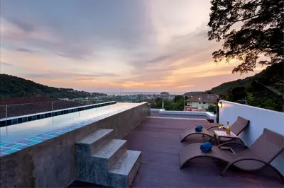 a rooftop patio with benches and a swimming pool at Splendid Sea View Resort in Kata Beach