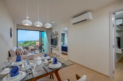 a living room with a table and a living room at Splendid Sea View Resort in Kata Beach