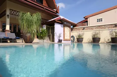 a swimming pool in front of a house at Beautiful 5BR Villa Felicity, Pool & Garden, near Naiharn in Rawai Beach