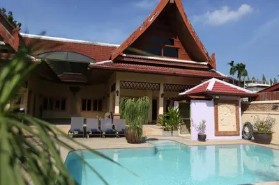 a house with a swimming pool in front of it at Beautiful 5BR Villa Felicity, Pool & Garden, near Naiharn in Rawai Beach