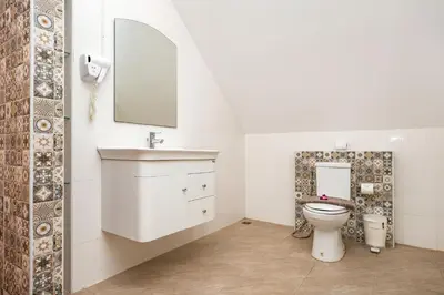 a bathroom with a toilet and a sink at Beautiful 5BR Villa Felicity, Pool & Garden, near Naiharn in Rawai Beach