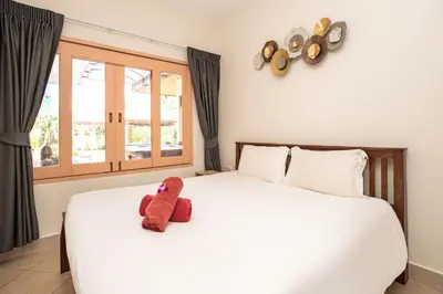 a stuffed animal sitting on top of a bed at Beautiful 5BR Villa Felicity, Pool & Garden, near Naiharn in Rawai Beach