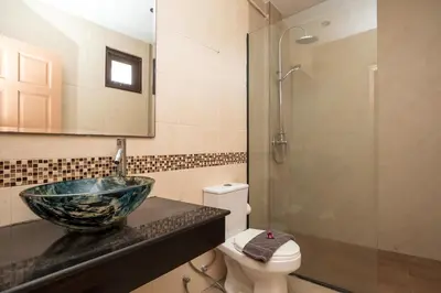 a bathroom with a glass bowl sink and a toilet at Beautiful 5BR Villa Felicity, Pool & Garden, near Naiharn in Rawai Beach