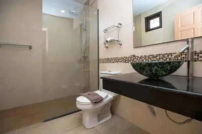 a bathroom with a sink and a toilet and a shower at Beautiful 5BR Villa Felicity, Pool & Garden, near Naiharn in Rawai Beach