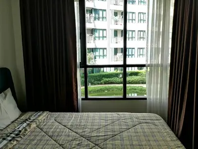 a bedroom with a bed and a large window at 2 Floor - Centrio Condominium near Central Shopping Mall and Phuket Old town in Phuket Town