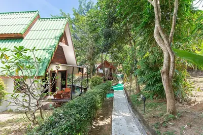 a house with a green roof and a path next to it at Harmony Naturist Resort Rawai Phuket 18yr minimum age only nudist nake d FKK in Rawai Beach
