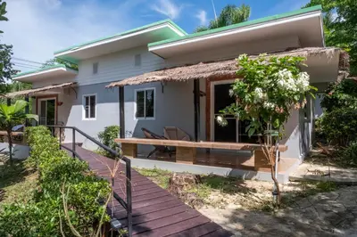 a small white house with a deck at Harmony Naturist Resort Rawai Phuket 18yr minimum age only nudist nake d FKK in Rawai Beach