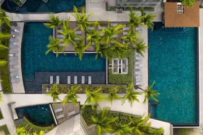 an aerial view of a resort with palm trees and a pool at Oceanfront Beach Resort in Patong Beach