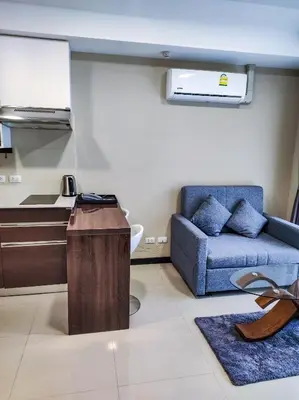 a living room with a couch and a table at MBC Mai Khao Beach Condotel LUXURY APARTMENTs in Phuket Town