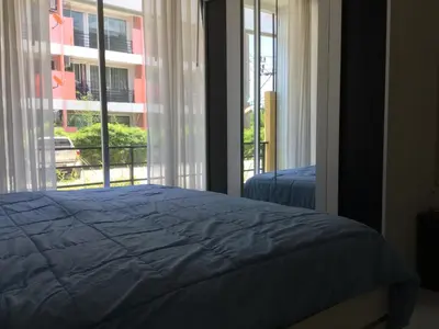 a bedroom with a bed and a large window at Best Point Condominium Cape Panwa in Phuket Town